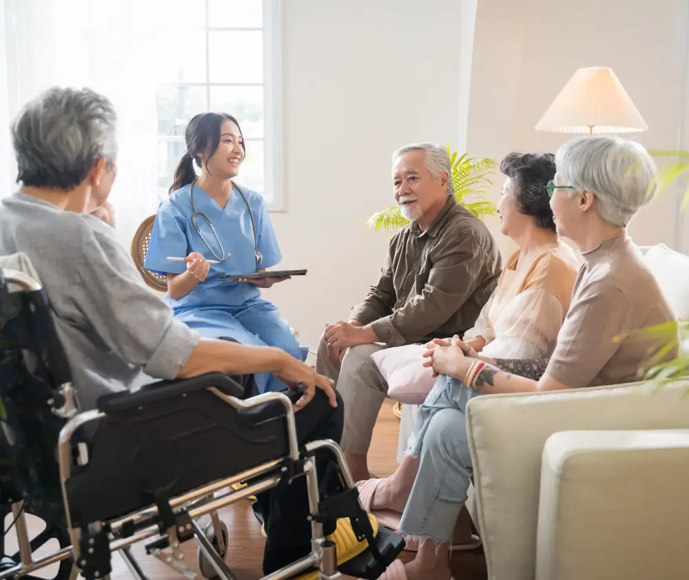 Group of Asian senior people sit in a circle in a nursing home and listen to nurse during a group elderly therapy session Group of Asian senior people sit in a circle in a nursing home and listen to nurse during a group elderly therapy session
